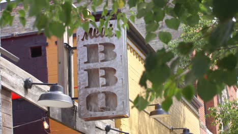 Meat-BBQ-restaurant-sign-in-Lansing,-Michigan-Old-Town-district-with-stable-establishing-shot