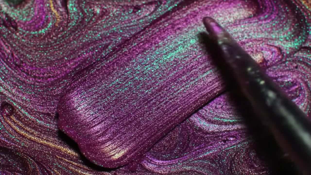 Close-up of purple iridescent glitter nail polish
