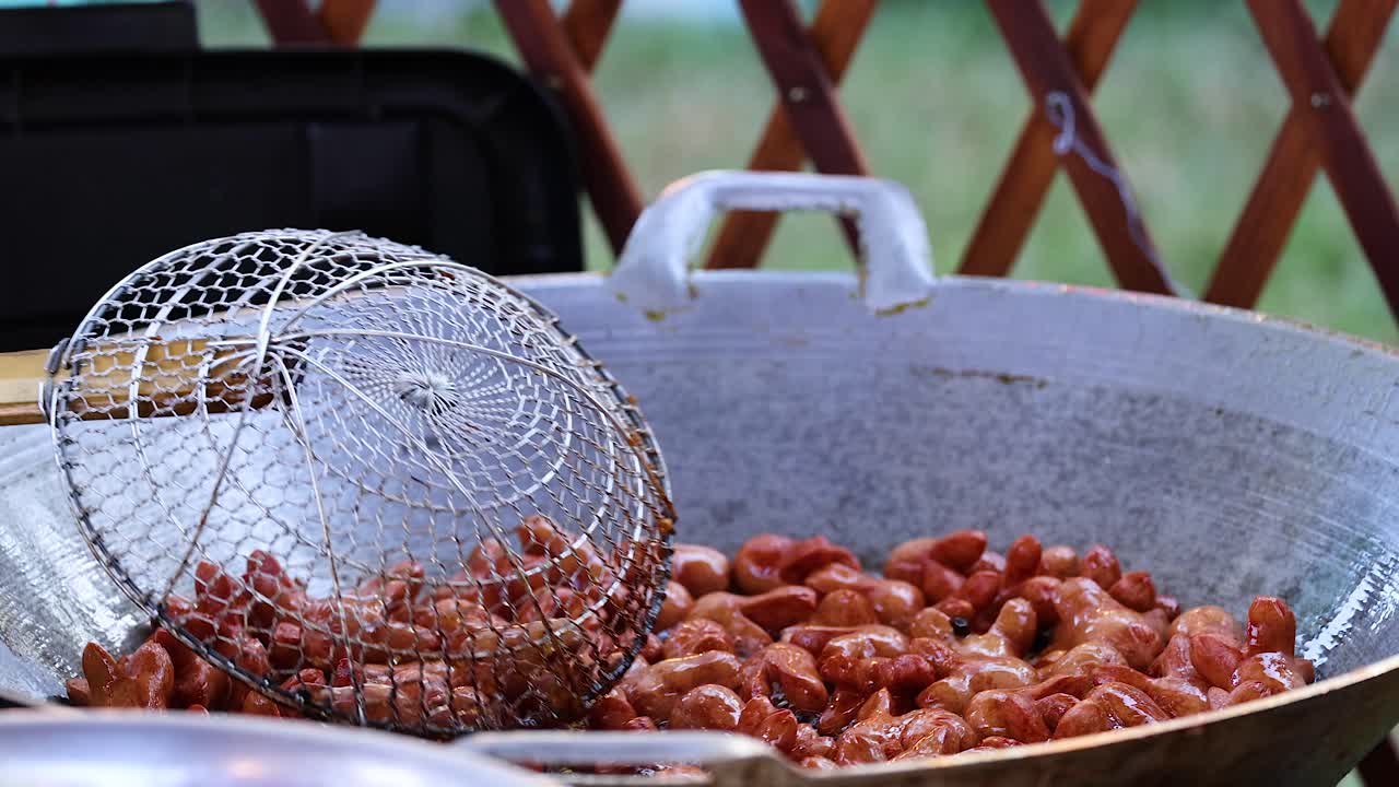 큰 야외 판 에 소시지 를 요리 하는 것