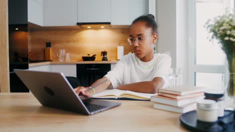 girl studying online in kitchen