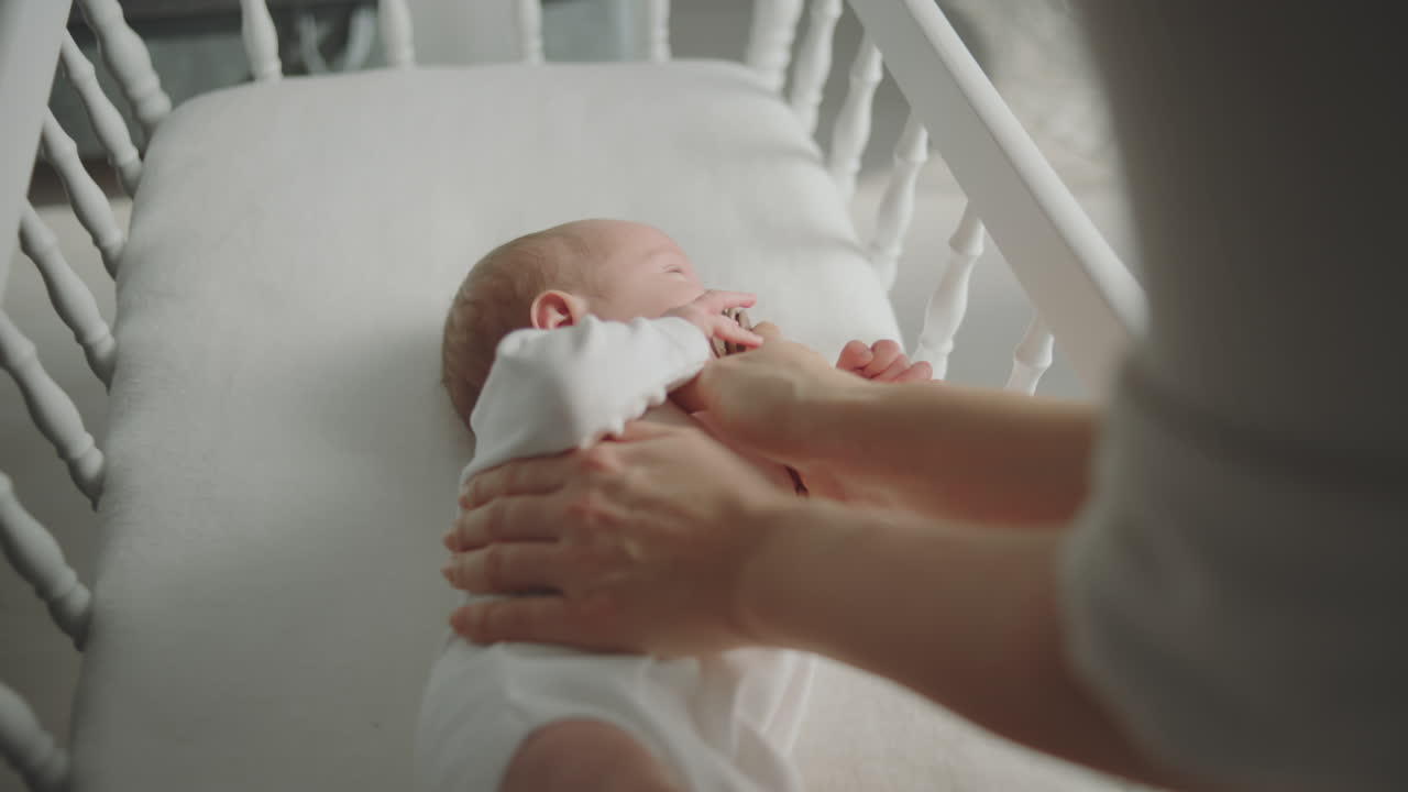 Madre che accudisce il neonato nella culla