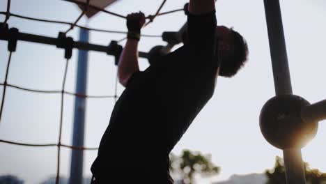 side view close up of an athletic caucasian man cross training in a park