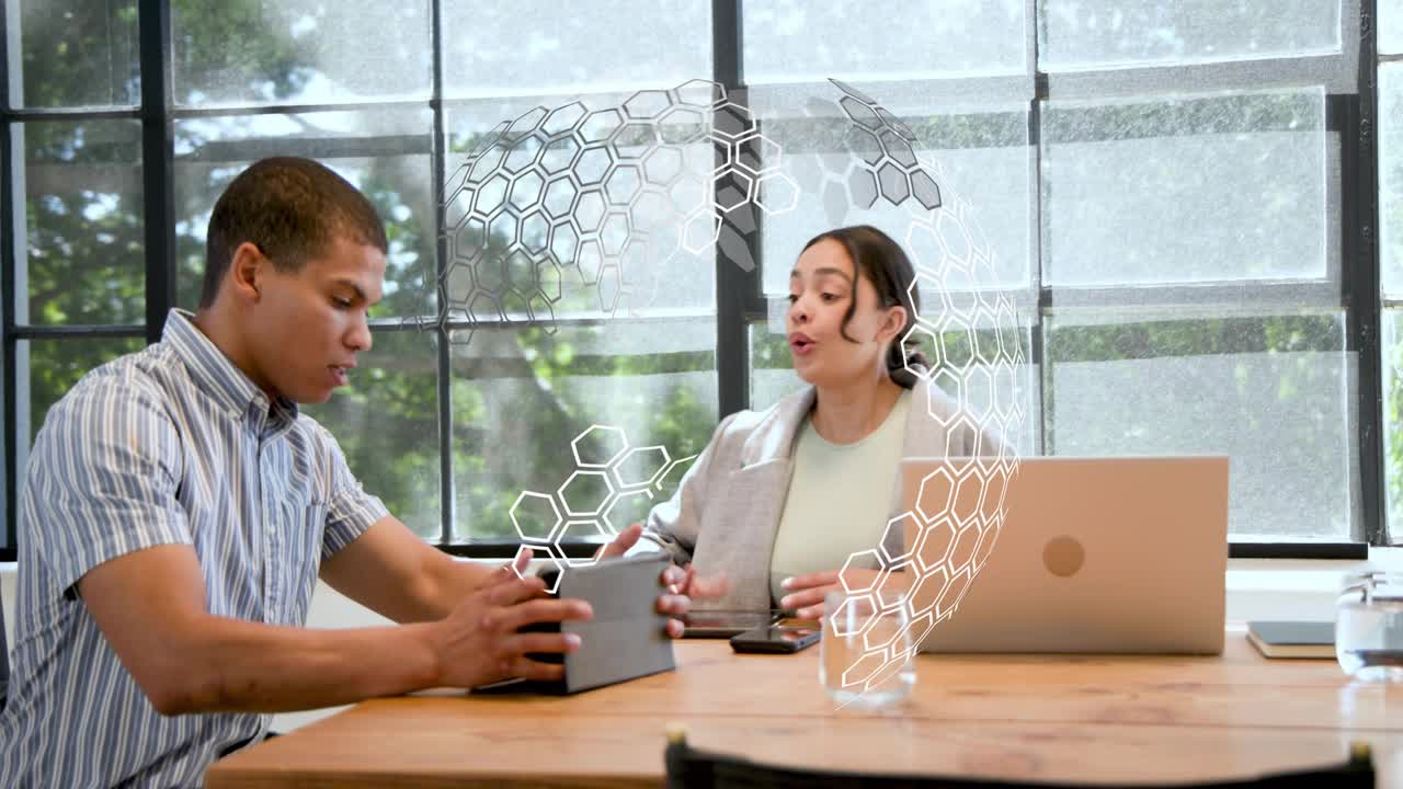 Male colleague handing tablet and initiating hex HUD overlay, colleagues reviewing business charts