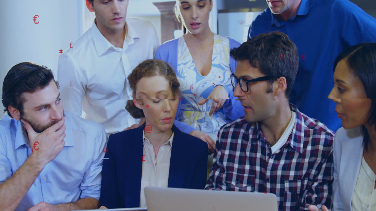 Team brainstorming business strategy around laptop, showcasing animated financial charts and icons