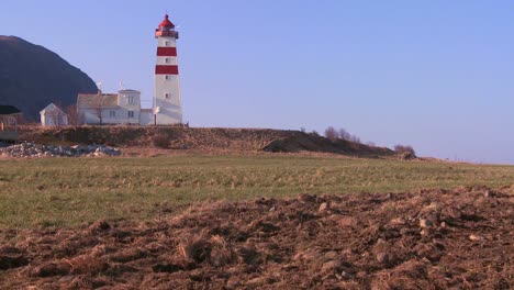 Establishing-shot-of-small-picturesque-fishing-village-with-lighthouse-along-the-coast-of-Norway-2