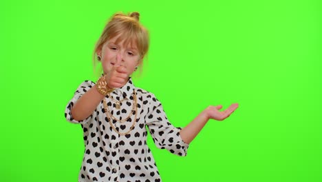 Funny-child-girl-showing-thumbs-up-and-pointing-empty-place,-advertising-area-for-commercial-text