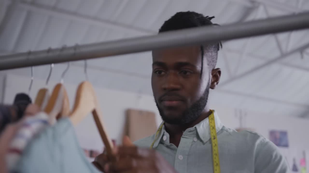 Mixed race man working in fashion office