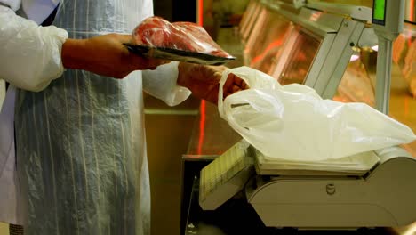 butcher weighing meat in butchers shop 4k