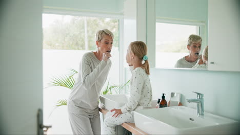 Grandmother,-child-and-brushing-teeth-in-bathroom