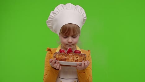 little chef blowing on a delicious cake