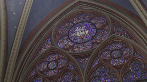 stained glass window in notre-dame de paris with intricate design and vibrant colors