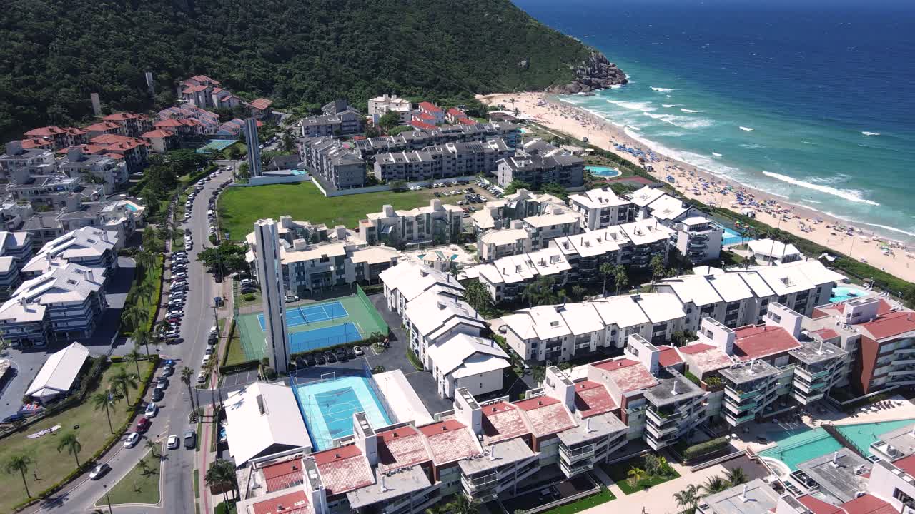 Panoramic aerial view of Brava Beach in Florianópolis with several condominiums, apartments, vacation homes in front of the beach, high season in front of the sea and coastal areas for tourists