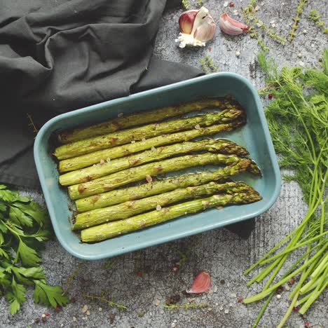 roasted asparagus seasoned with salt  pepper  garlic and decorated with fresh herbs