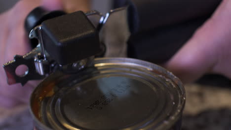 Close-Up-Of-Can-Opener-Being-Used-By-Female-Hands