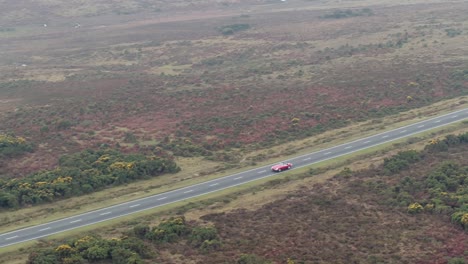 aerial drone shot tracking car on open road