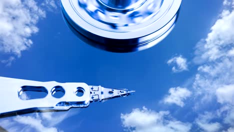 cinemagraph, hard disk drive with reflected in it the time-lapse of clouds, the concept of cloud storage, video loop