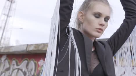 stylish woman in black jacket with white fringe