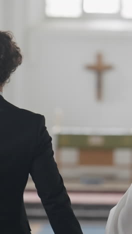 couple holding hands in church