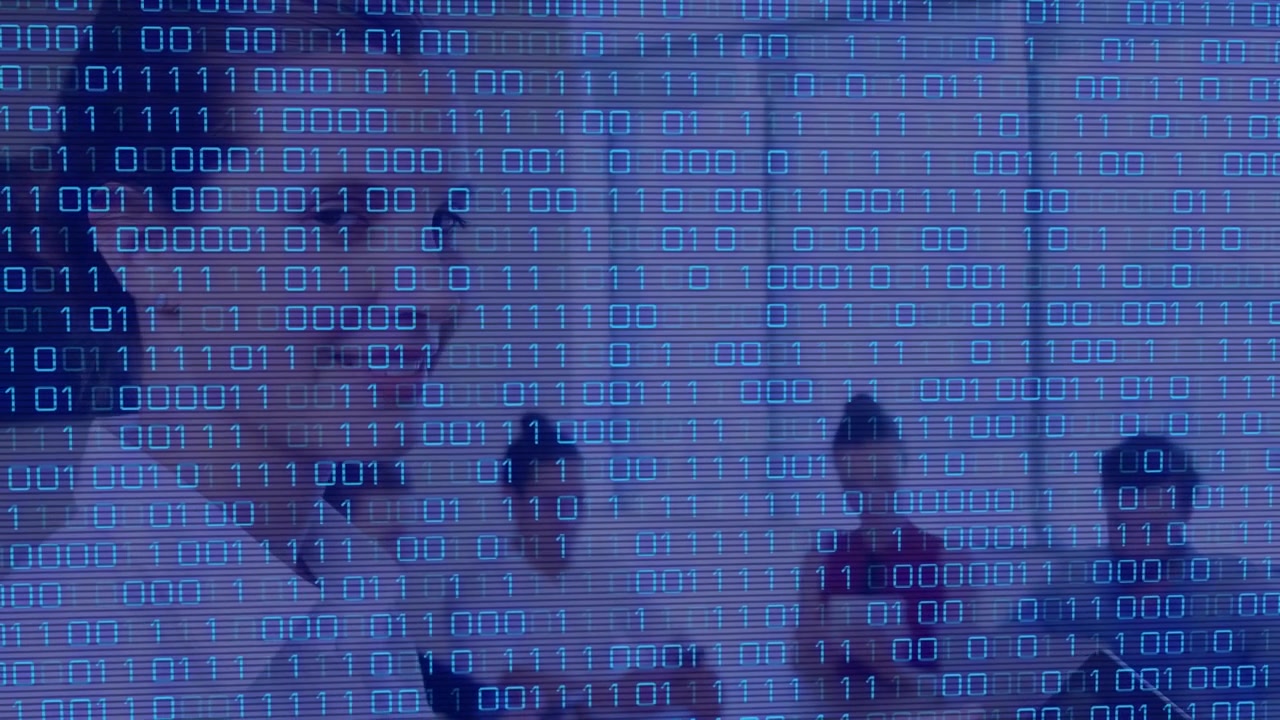 Animation of binary code over diverse businesspeople in office