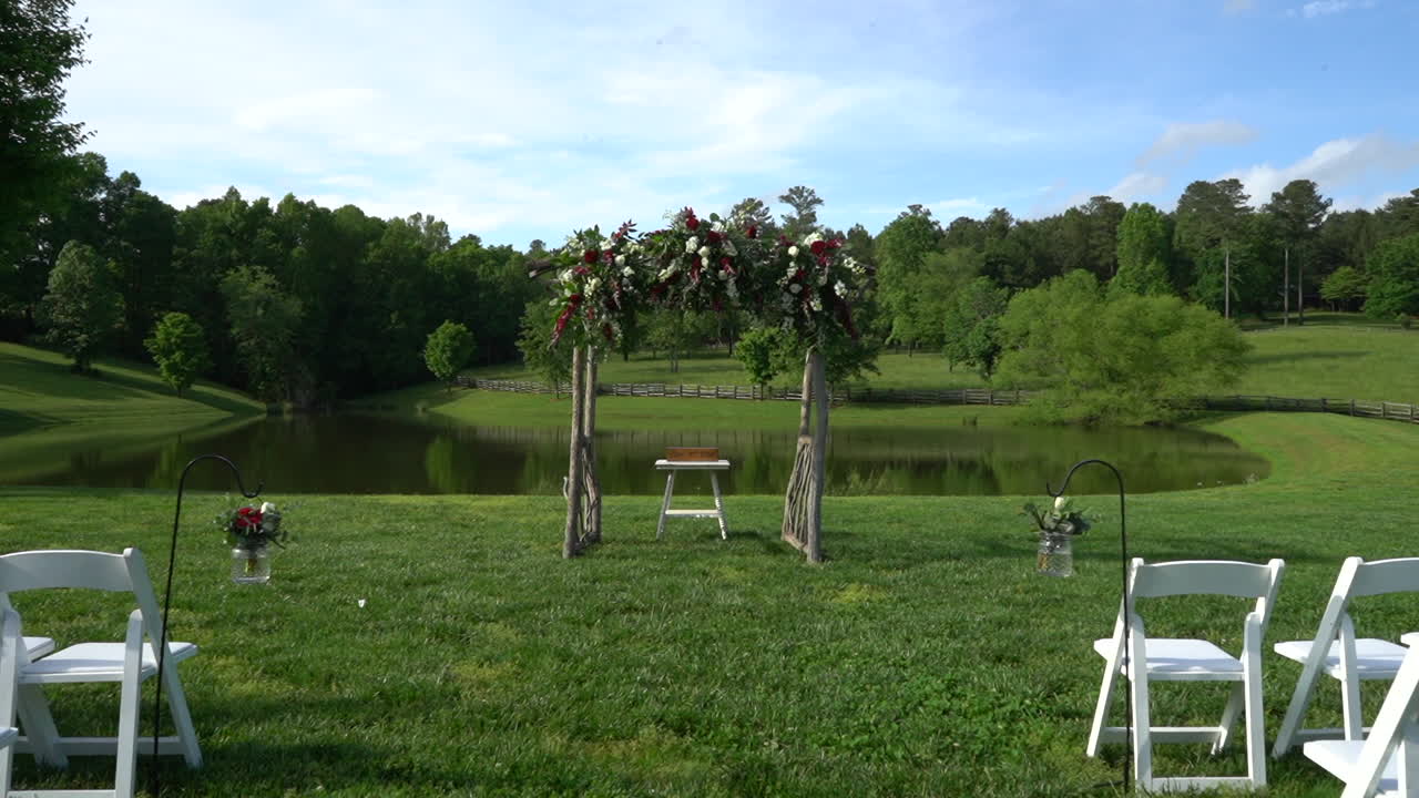 Outdoor wedding ceremony set up by the lake, beautiful natural landscape summer event