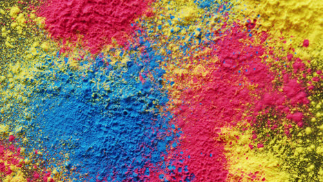 video of close up of multi coloured powders with copy space on black background