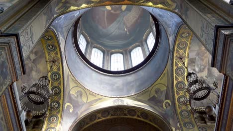 ornate church interior with religious paintings and mosaics