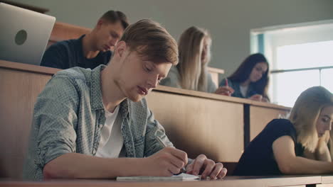 Students-at-a-university-or-college-write-a-lecture-on-a-laptop.-Graduate-at-the-Institute.