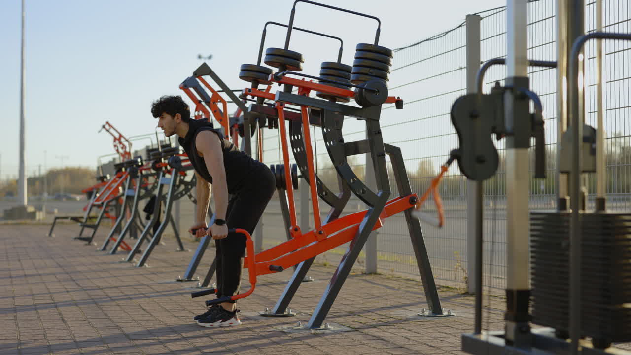 Man working out outdoors on exercise machines