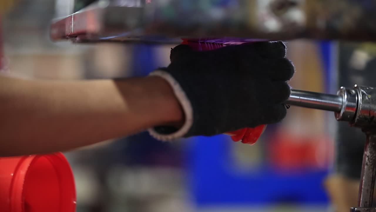 Pad Printing Process: Close-up View of a Red Plastic Container Being Printed