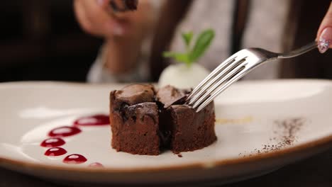 woman eating chocolate fondant cake