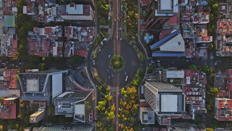 mexico city aerial v25 vertical drone flyover downtown across paseo de la reforma capturing traffics at the roundabouts and angel of independence at sunset - shot with mavic 3 cine - december 2021