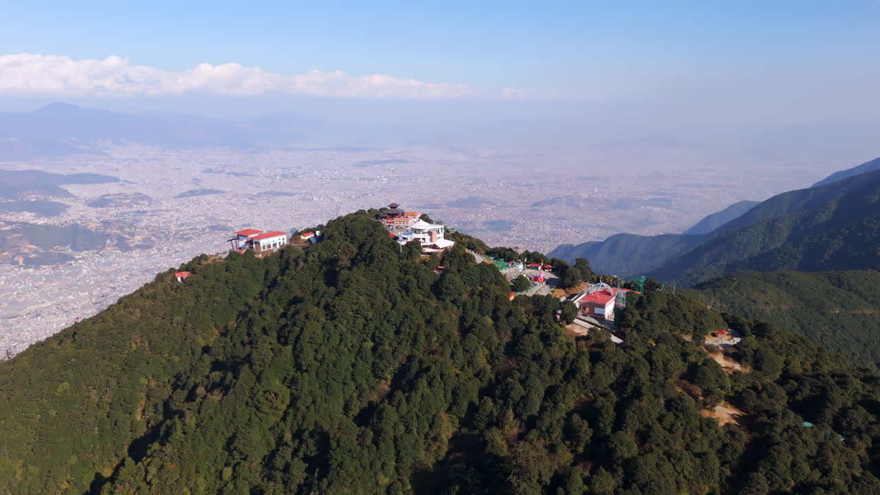 Drone orbiting the Chandragiri hill in front of Kathmandu, sunny day in Nepal