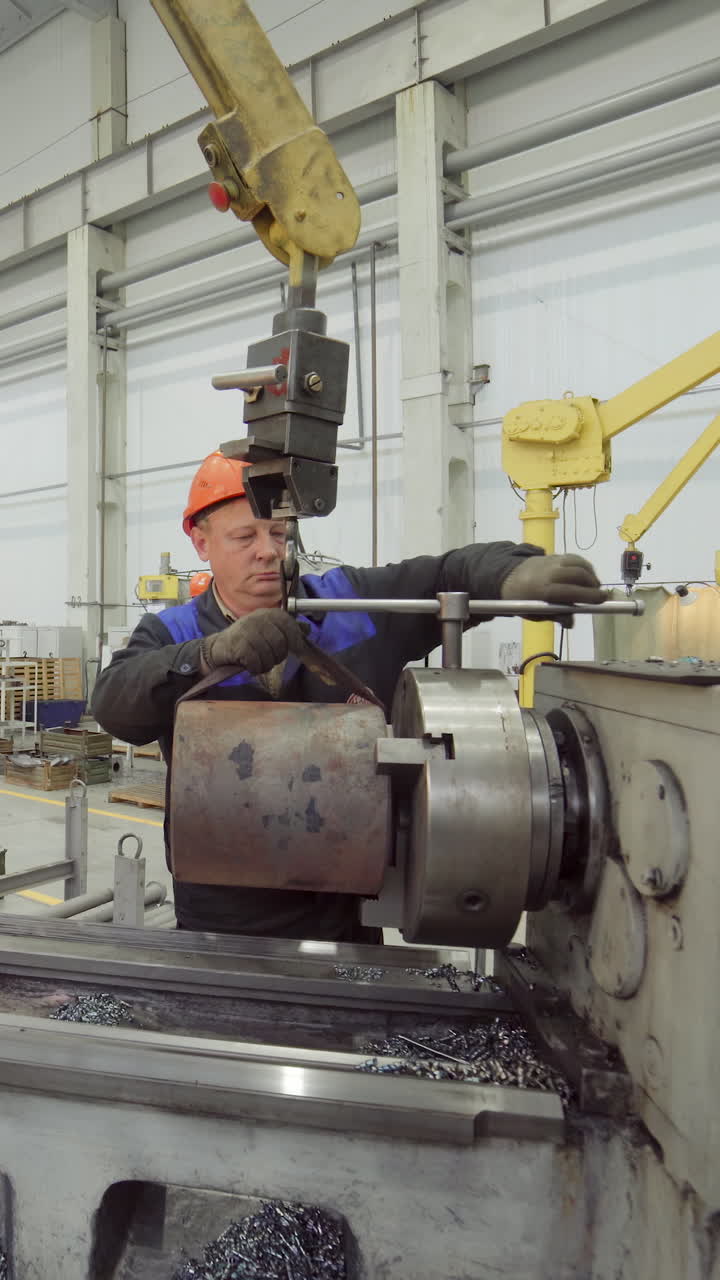 Worker operating a lathe machine in a factory | Premium Stock Video Footage