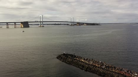 A-low-angle-view-of-a-stone-jetty-with-people-on-it