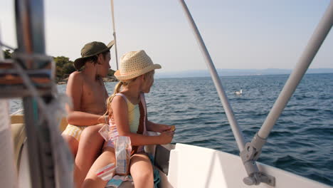 siblings enjoying a summer boat trip