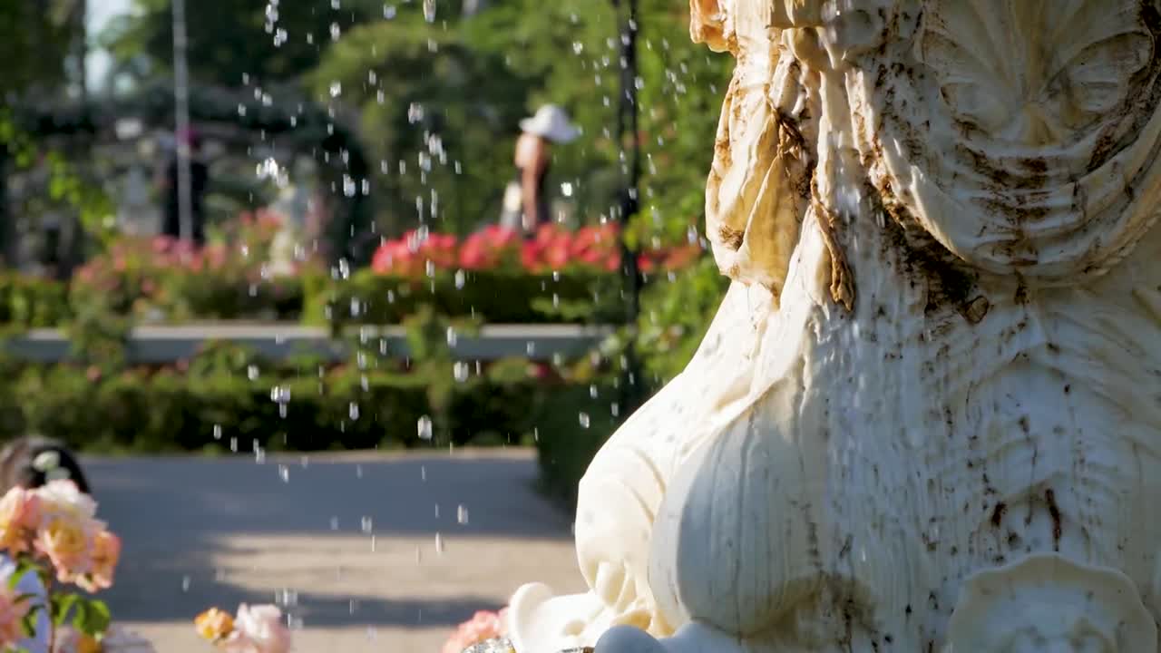 Close up of a raining marble fountain in a city park. Serene and picturesque urban scene.