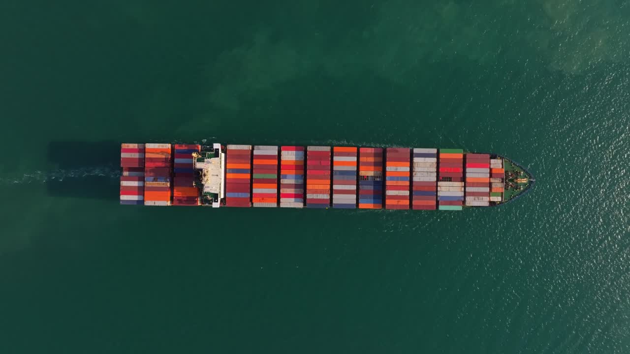 Trade ship navigating out of the harbor, Thailand