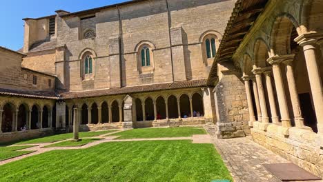 stone architecture surrounding a lush green courtyard