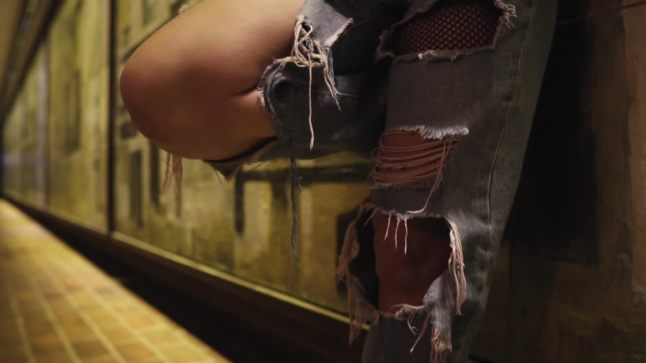 Premium stock video - Trendy latina tennager dancer chilling relax by the wall in ripped jeans