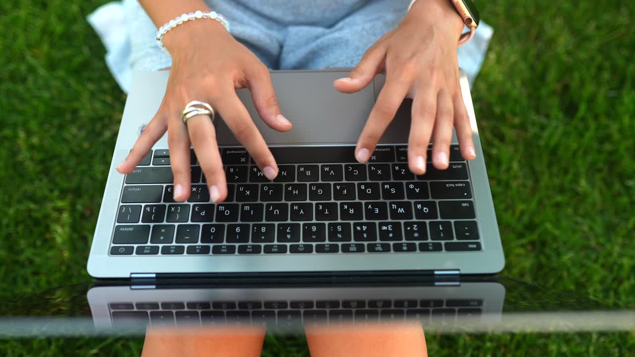 Woman working on a laptop outdoors