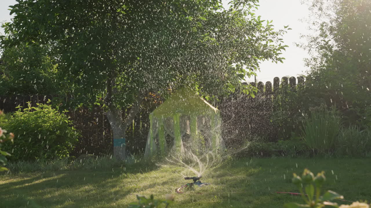 White Girl Running Through Sprinkler With Dog, Wet Grass Spray And Joyful Motion, Playful Chase Around Yellow Playhouse, Summer Sunlight Sparkling Droplets, Candid Pet Companionship