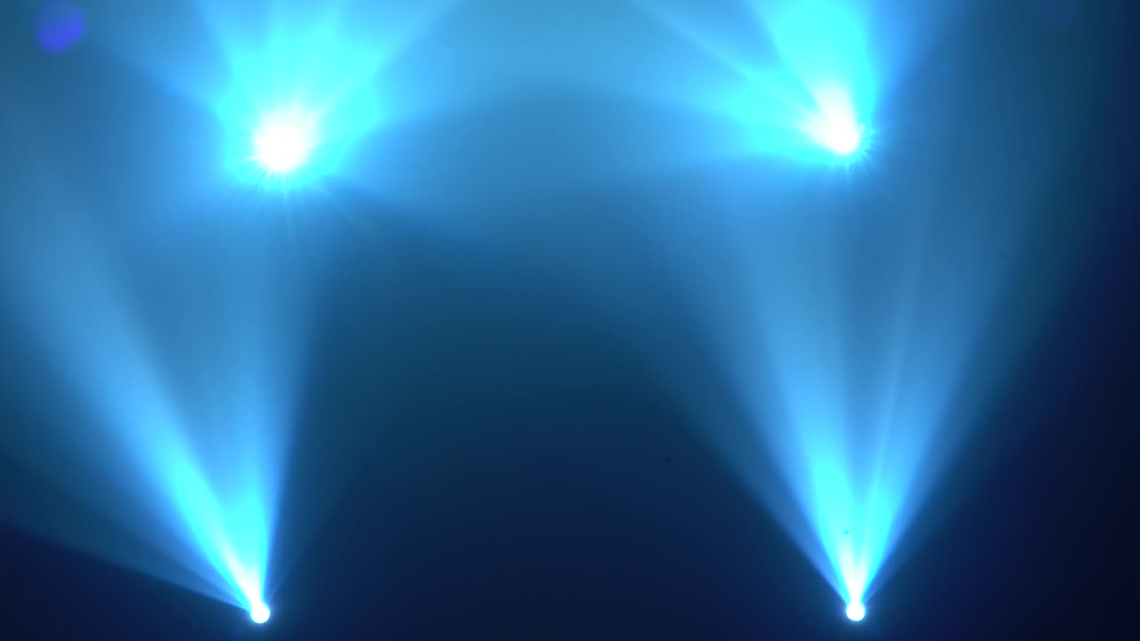 Blue light from the spotlights through the smoke