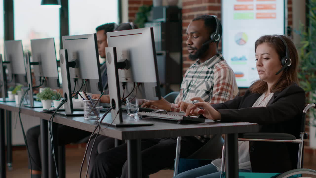 Female worker in wheelchair working on telecommunications