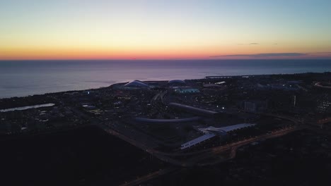sunrise over coastal city with modern architecture