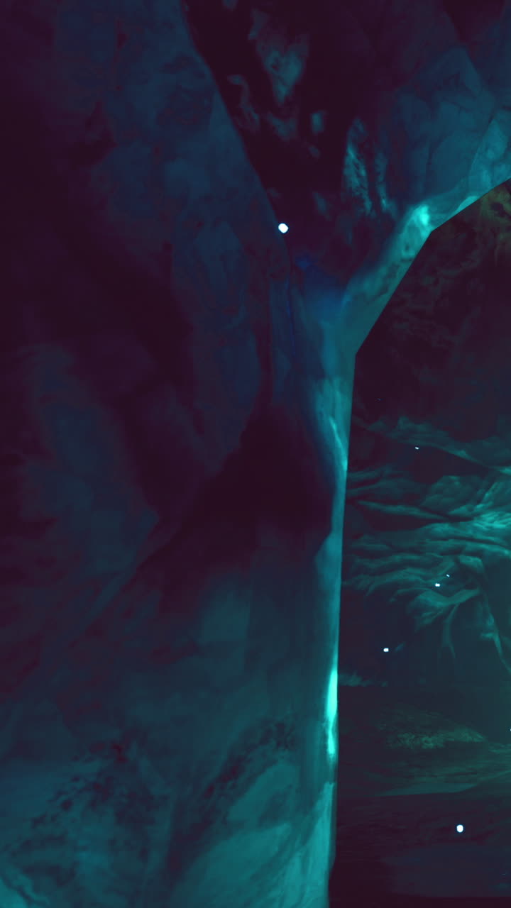 Underwater cave with distinct lighting effects in a dark environment