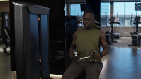man working out on a seated row machine in a gym