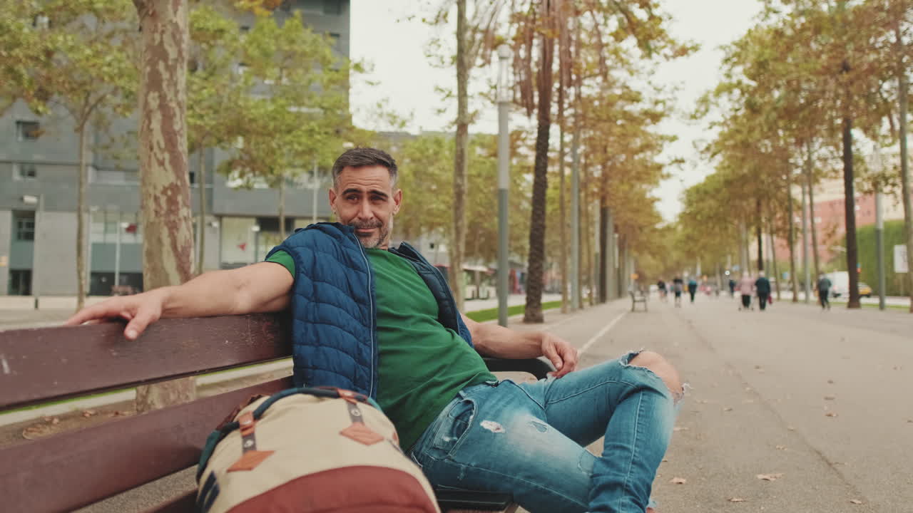 Man relaxing on a bench in a city park