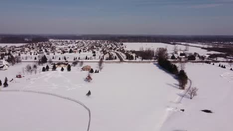Townscape-Near-Deep-Snow-Farmland-With-Cars-Traveling-On-Countryroad-In-Flat-Rock,-Michigan