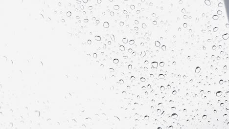 water droplets falling on a car glass