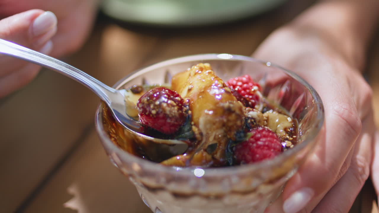 카페에서 디저트 베리를 먹는 여자 손. 카라멜 무스를 먹는 여자